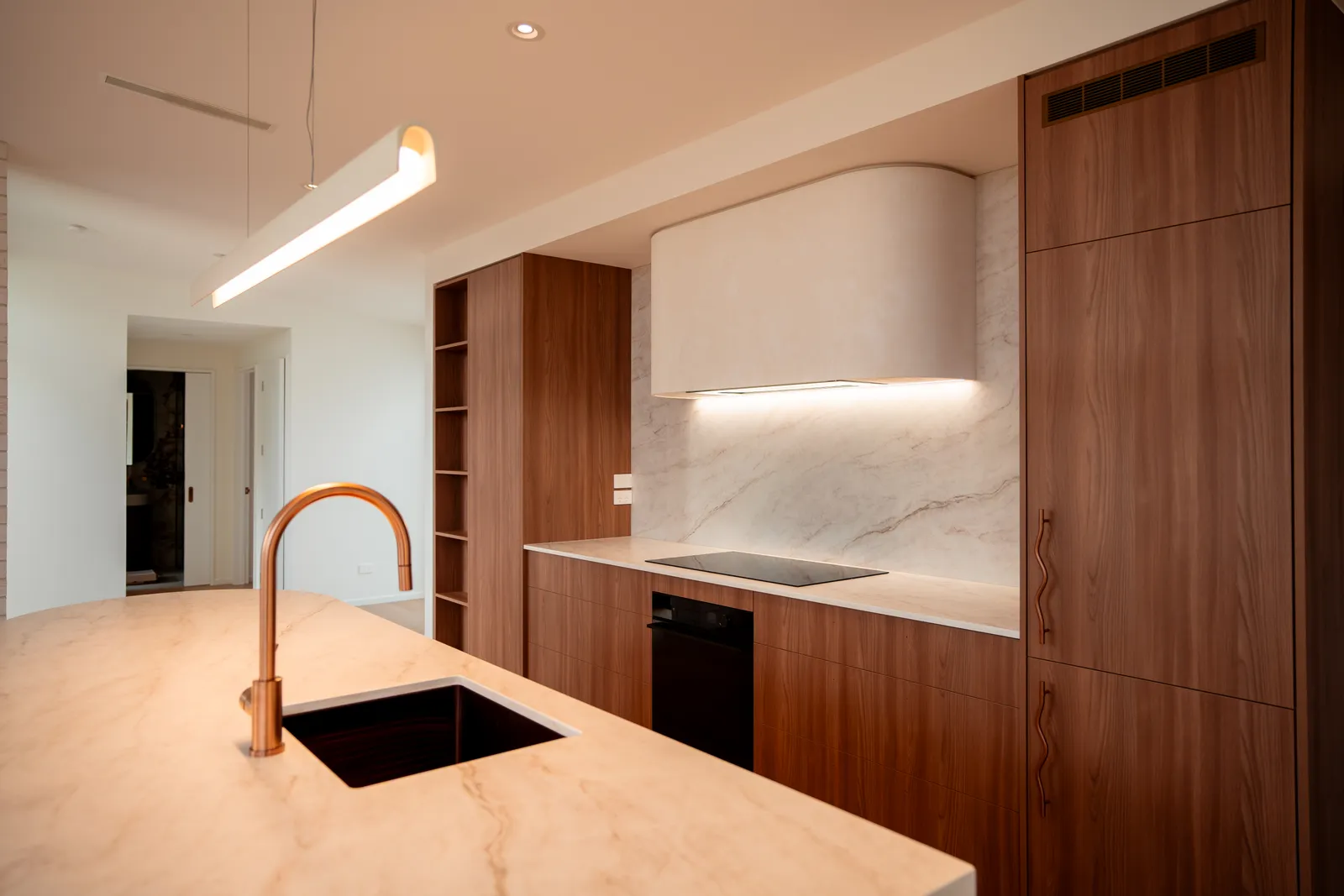 Kitchen with marble benchtop, copper tap, and island