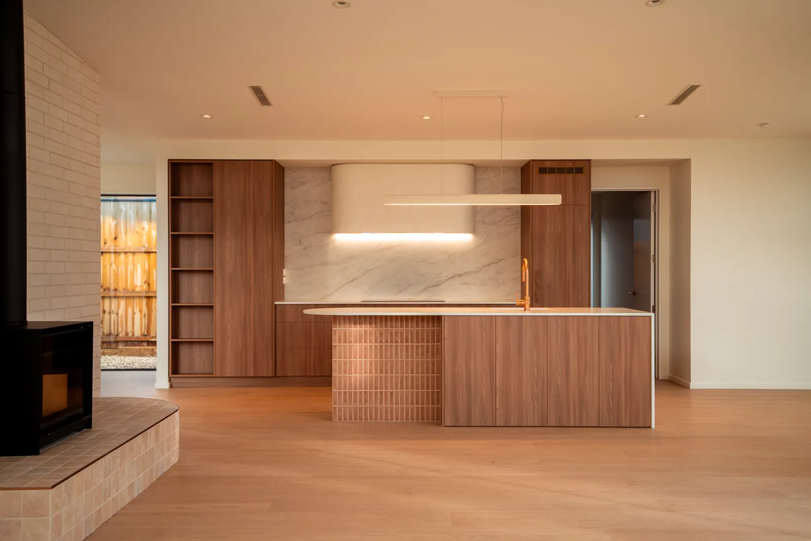 Kitchen and living with a marble waterfall island